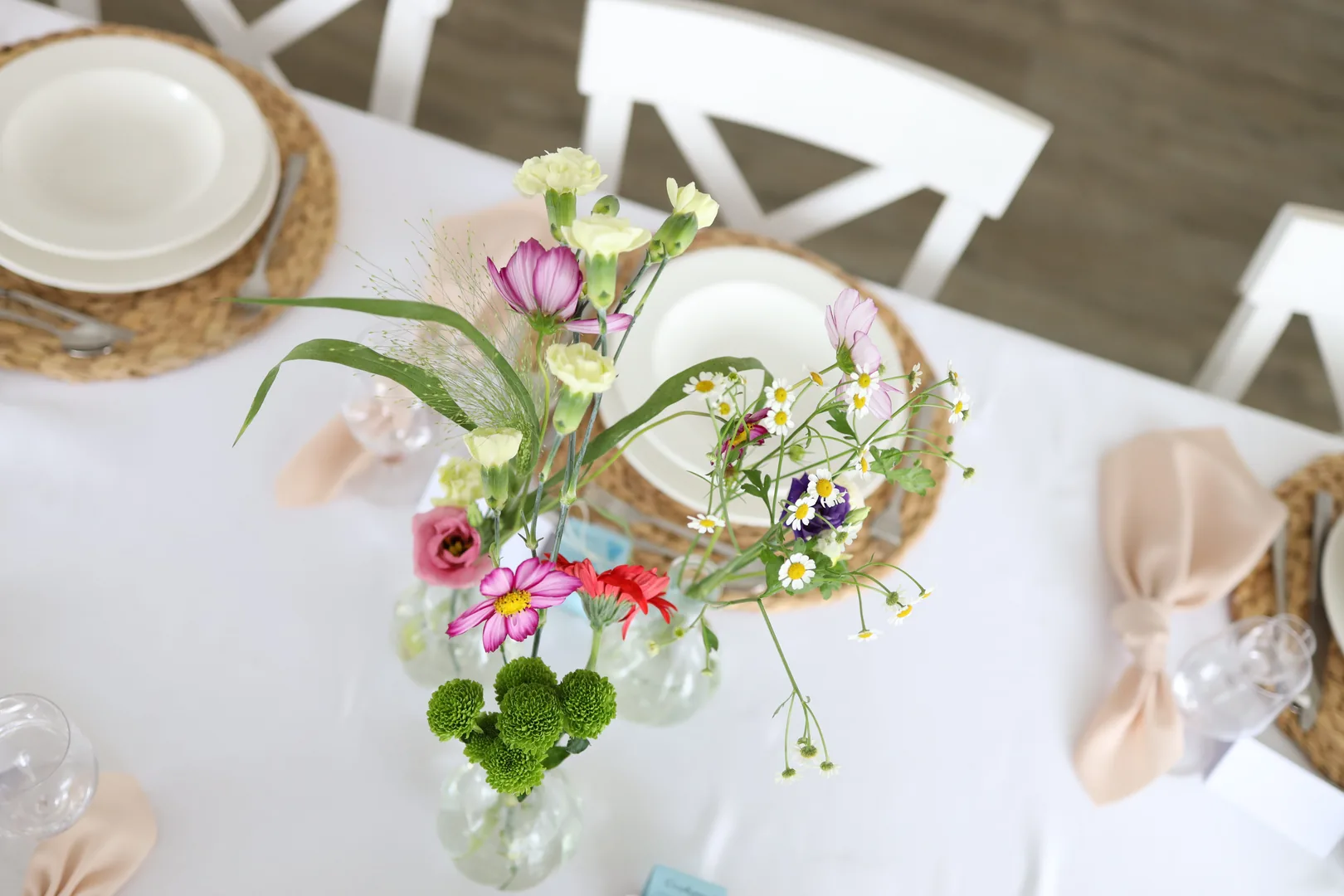Top view of vases with cosmoses, cream carnations, red gerbera, eustoma and green chrysanthemums